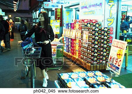 School girl pushing a bicycle View Large Photo Image Stock Photography - School girl pushing a bicycle. Fotosearch
