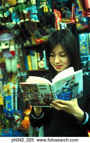 Stock Photography - School girl reading a book. Fotosearch