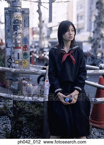 School girl sitting on a metal railing View Large Photo Image Stock Image - School girl sitting on a metal railing. Fotosearch