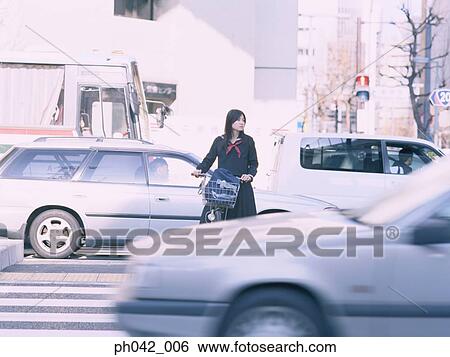 School girl waiting to cross the road View Large Photo Image Stock Photograph - School girl waiting to cross the road. Fotosearch