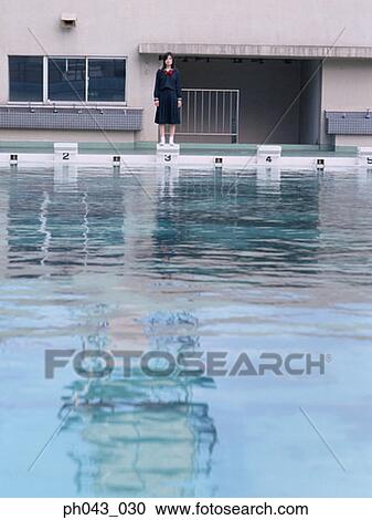 Stock Image - School girl at the swimming pool. Fotosearch