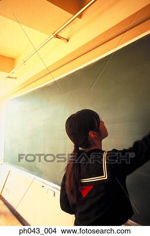 Picture - School girl cleaning the blackboard. Fotosearch