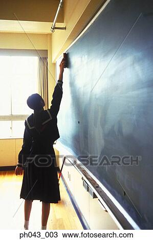 School girl cleaning the blackboard View Large Photo Image Stock Image - School girl cleaning the blackboard. Fotosearch