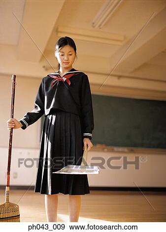 Stock Photo - School girl cleaning the classroom. Fotosearch