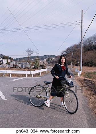 Picture - School girl cycling. Fotosearch