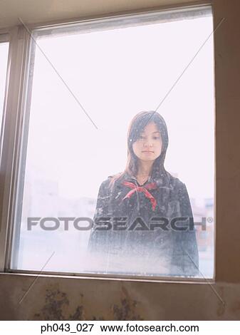 Stock Photo - School girl looking in from outside. Fotosearch
