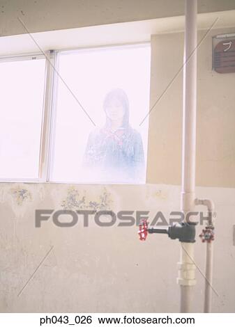 Stock Photograph - School girl looking in from outside. Fotosearch