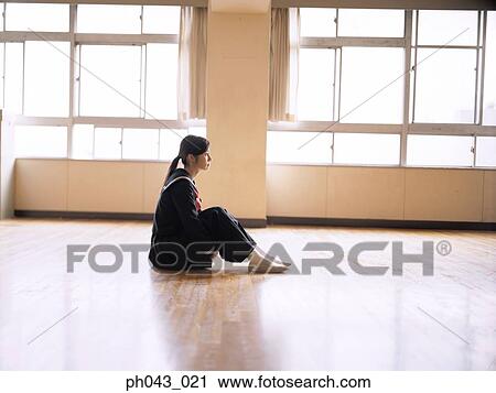 Stock Image - School girl sitting in the classroom. Fotosearch