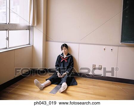 Stock Photo - School girl sitting in the classroom. Fotosearch