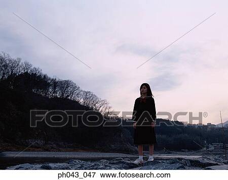 School girl standing along the river bed View Large Photo Image Stock Photo - School girl standing along the river bed. Fotosearch