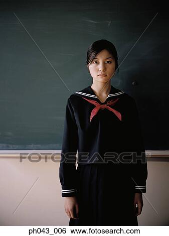School girl standing in front of a blackboard View Large Photo Image Stock Photograph - School girl standing in front of a blackboard. Fotosearch