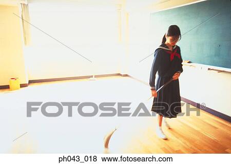Stock Photo - School girl sweeping the floor. Fotosearch
