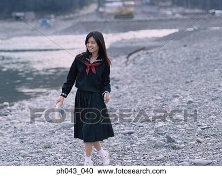 School girl walking along the river bed View Large Photo Image Stock Image - School girl walking along the river bed. Fotosearch