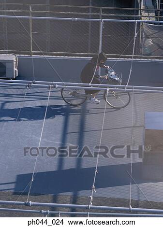 School girl cycling in the void deck View Large Photo Image Picture - School girl cycling in the void deck . Fotosearch