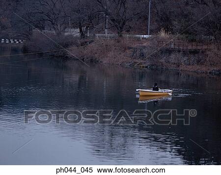 Stock Photography - School girl rowing a boat. Fotosearch