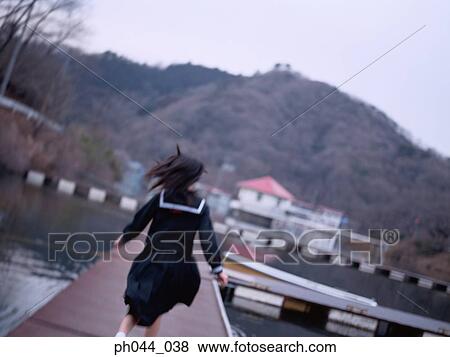 School girl running on the pathway View Large Photo Image Stock Photo - School girl running on the pathway. Fotosearch