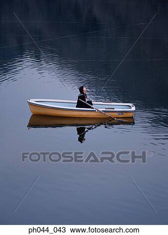 Stock Image - School girl sitting in a boat. Fotosearch