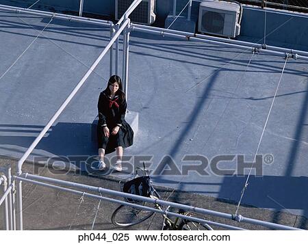 Stock Photography - School girl sitting in the void deck. Fotosearch