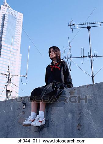 School girl sitting on the roof top View Large Photo Image Stock Image - School girl sitting on the roof top. Fotosearch