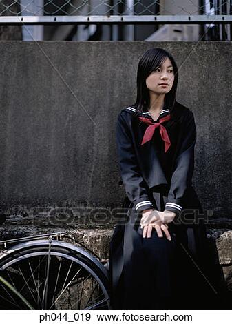Stock Photo - School girl sitting. Fotosearch