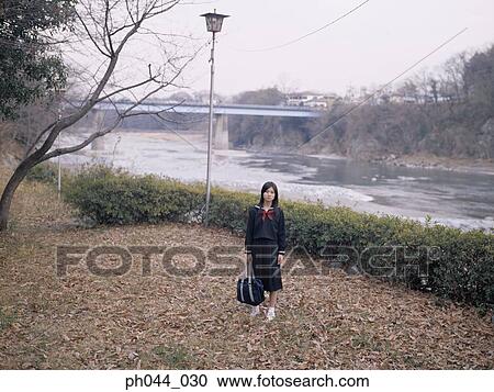 School girl standing in the park View Large Photo Image Stock Image - School girl standing in the park. Fotosearch