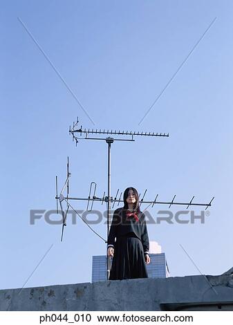 School girl standing on the roof top View Large Photo Image Stock Image - School girl standing on the roof top. Fotosearch