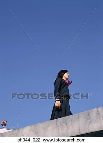 School girl standing on the roof top View Large Photo Image Stock Image - School girl standing on the roof top. Fotosearch