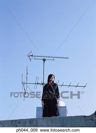 School girl standing on the roof top View Large Photo Image Stock Photo - School girl standing on the roof top. Fotosearch