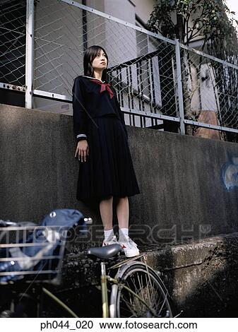 Stock Image - School girl standing. Fotosearch
