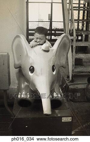 Boy on amusement elephant ride View Large Photo Image Picture - Boy on amusement elephant ride. Fotosearch
