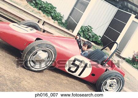 Boy on amusement racing car ride View Large Photo Image Stock Photo - Boy on amusement racing car ride. Fotosearch