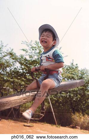 Stock Image - Boy playing in the playground. Fotosearch