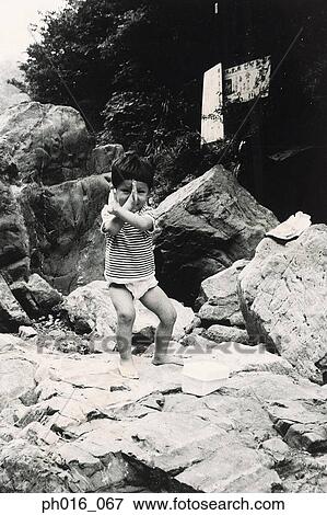 Stock Photo - Boy posing on rocks. Fotosearch