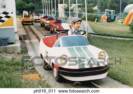 Boy sitting on a amusement car ride View Large Photo Image Stock Image - Boy sitting on a amusement car ride. Fotosearch