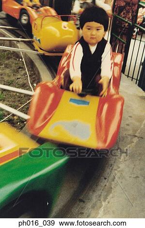 Boy sitting on a amusement car ride View Large Photo Image Stock Photo - Boy sitting on a amusement car ride. Fotosearch
