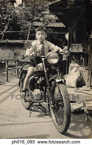 Stock Image - Boy sitting on a motorcycle. Fotosearch