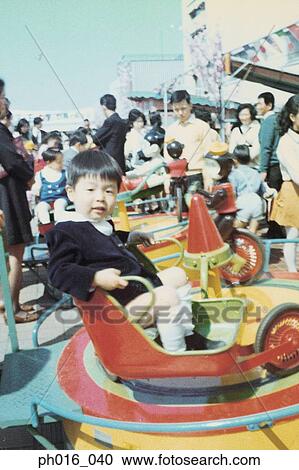 Boy sitting on a spaceship ride View Large Photo Image Stock Image - Boy sitting on a spaceship ride. Fotosearch