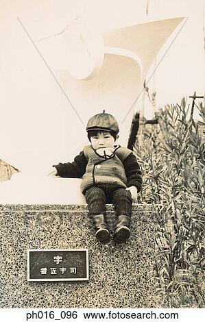 Boy sitting on the concrete wall View Large Photo Image Stock Photograph - Boy sitting on the concrete wall. Fotosearch