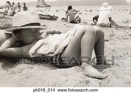 Boy sleeping on the beach View Large Photo Image Picture - Boy sleeping on the beach. Fotosearch