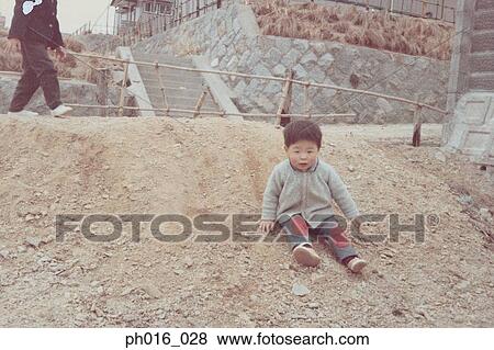 Boy Sliding Down A Slope Stock Photo Ph016 028 Fotosearch