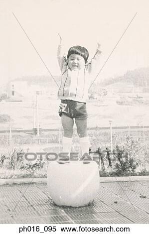 Boy standing on a round seat View Large Photo Image Stock Photography - Boy standing on a round seat. Fotosearch