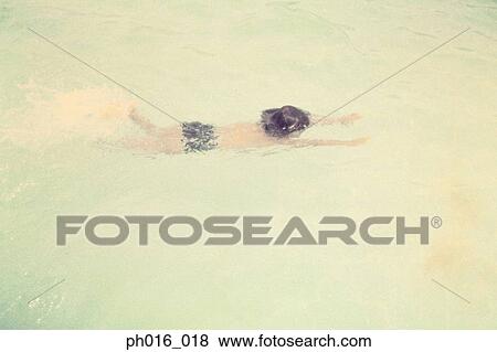 Boy swimming in a pool View Large Photo Image Stock Photo - Boy swimming in a pool. Fotosearch