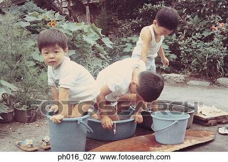 Boys playing in the backyard View Large Photo Image Stock Photo - Boys playing in the backyard. Fotosearch
