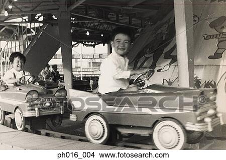 Children on a amusement car ride View Large Photo Image Picture - Children on a amusement car ride. Fotosearch
