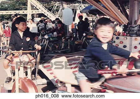 Stock Photo - Children on a amusement car ride. Fotosearch