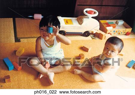 Stock Image - Children playing toys at home. Fotosearch