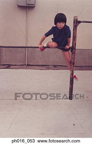 Girl climbing on monkey bar View Large Photo Image Stock Image - Girl climbing on monkey bar. Fotosearch