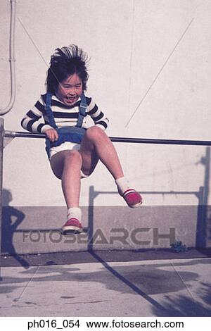 Girl hanging on a monkey bar View Large Photo Image Picture - Girl hanging on a monkey bar. Fotosearch