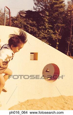 Picture - Girl jumping in the playground. Fotosearch
