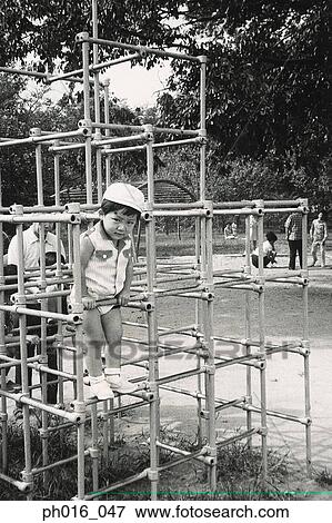 Girl playing in a playground View Large Photo Image Stock Photo - Girl playing in a playground. Fotosearch